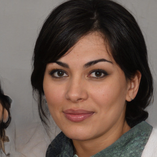 Joyful white young-adult female with medium  black hair and brown eyes