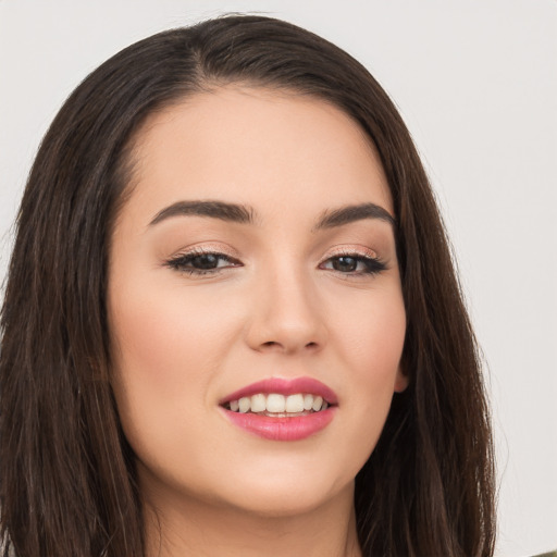 Joyful white young-adult female with long  brown hair and brown eyes