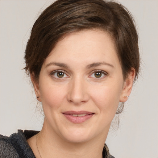 Joyful white young-adult female with medium  brown hair and grey eyes