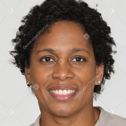 Joyful black adult female with short  brown hair and brown eyes