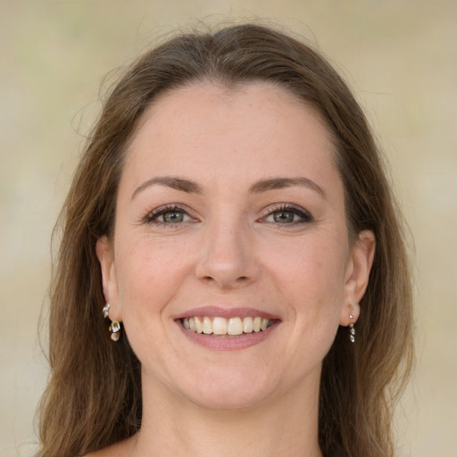 Joyful white young-adult female with long  brown hair and green eyes