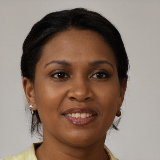 Joyful black young-adult female with medium  brown hair and brown eyes