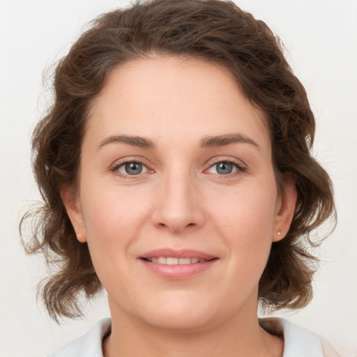 Joyful white young-adult female with medium  brown hair and green eyes