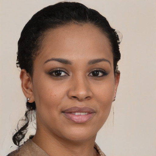 Joyful black young-adult female with short  black hair and brown eyes