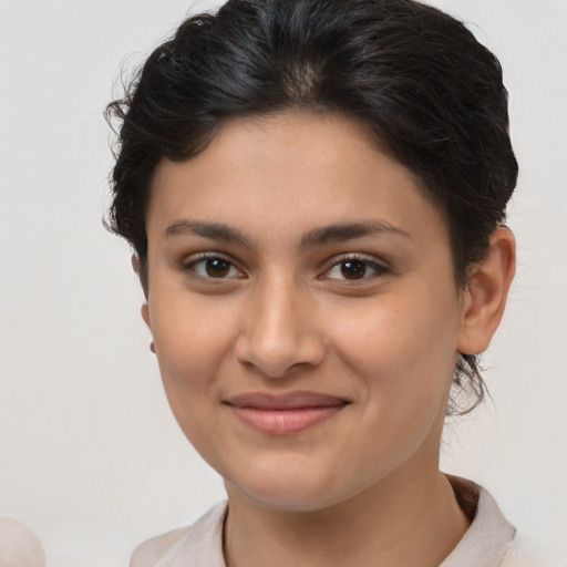 Joyful latino young-adult female with short  brown hair and brown eyes