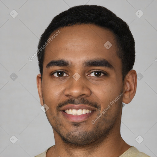 Joyful black young-adult male with short  black hair and brown eyes