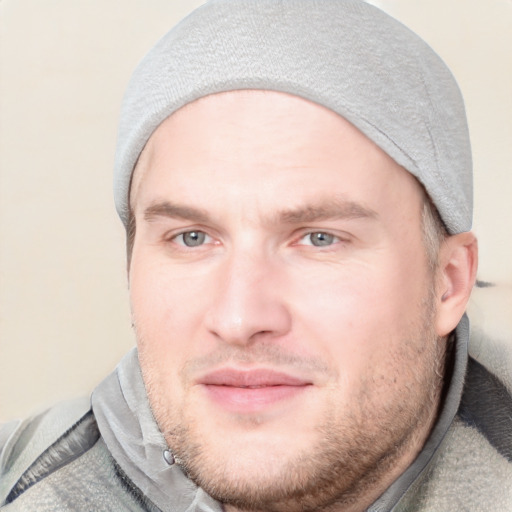 Joyful white young-adult male with short  brown hair and blue eyes