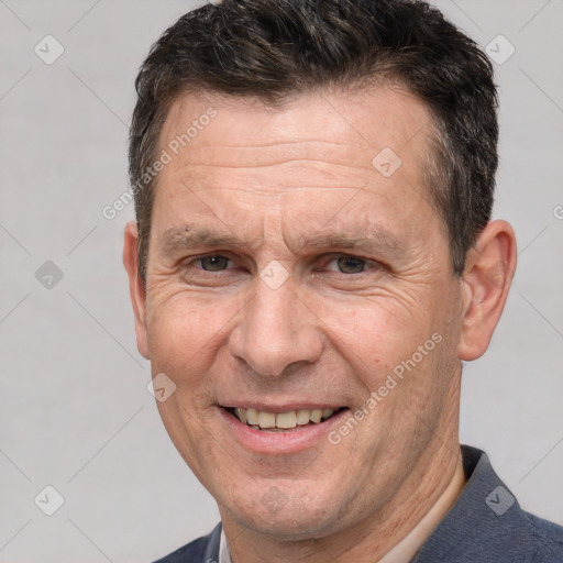 Joyful white middle-aged male with short  brown hair and brown eyes