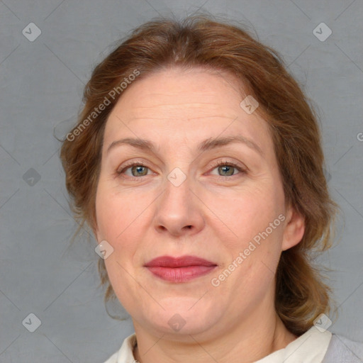 Joyful white adult female with medium  brown hair and blue eyes