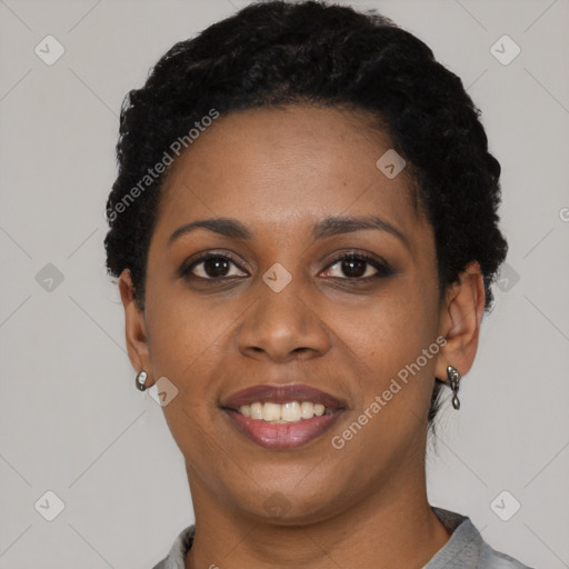 Joyful black young-adult female with short  black hair and brown eyes