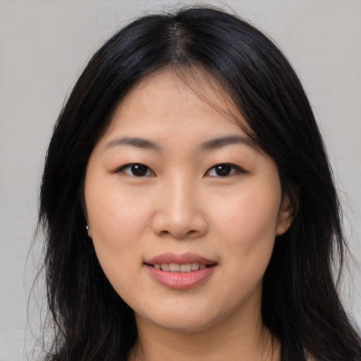 Joyful asian young-adult female with long  brown hair and brown eyes