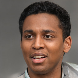 Joyful latino young-adult male with short  black hair and brown eyes