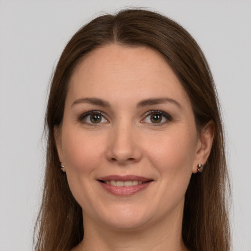 Joyful white young-adult female with long  brown hair and grey eyes