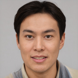 Joyful asian young-adult male with short  brown hair and brown eyes