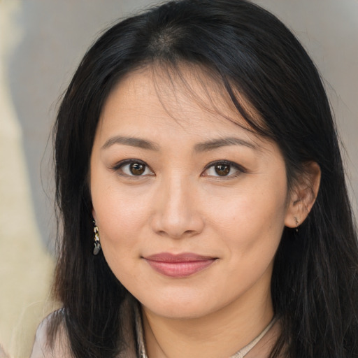 Joyful asian young-adult female with long  brown hair and brown eyes