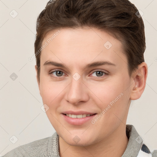 Joyful white young-adult female with short  brown hair and grey eyes