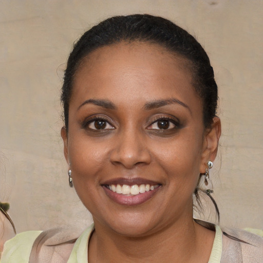 Joyful black young-adult female with short  brown hair and brown eyes