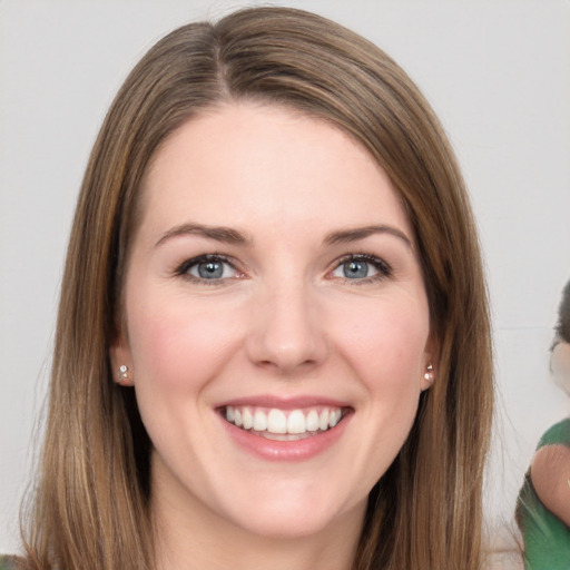 Joyful white young-adult female with long  brown hair and green eyes