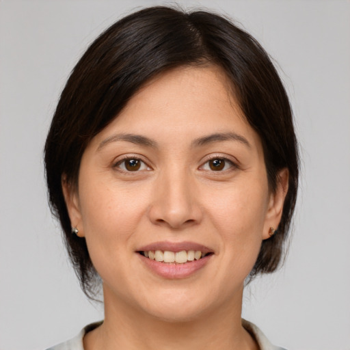 Joyful white young-adult female with medium  brown hair and brown eyes