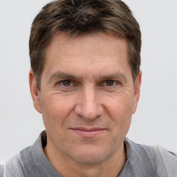 Joyful white adult male with short  brown hair and brown eyes