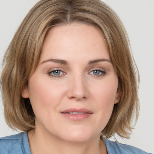 Joyful white young-adult female with medium  brown hair and blue eyes