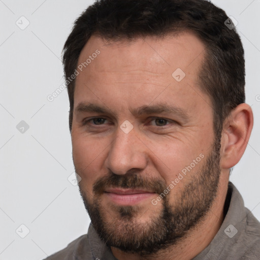 Joyful white adult male with short  brown hair and brown eyes