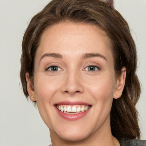 Joyful white young-adult female with medium  brown hair and green eyes