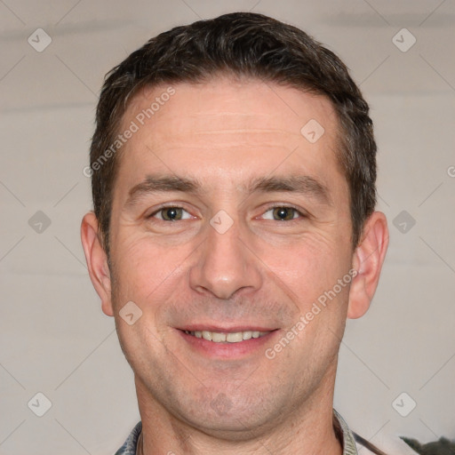 Joyful white adult male with short  brown hair and grey eyes