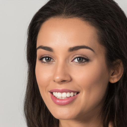 Joyful white young-adult female with long  brown hair and brown eyes