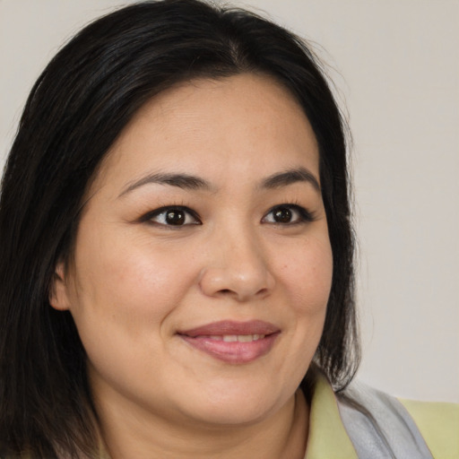 Joyful asian young-adult female with medium  brown hair and brown eyes