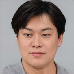 Joyful asian young-adult male with short  brown hair and brown eyes