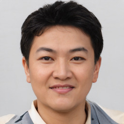 Joyful asian young-adult male with short  brown hair and brown eyes