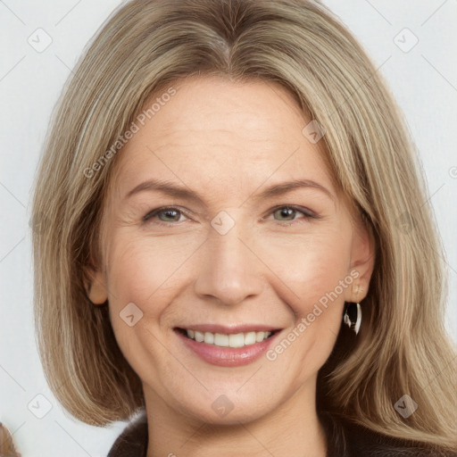 Joyful white adult female with long  brown hair and brown eyes