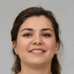 Joyful white young-adult female with medium  brown hair and brown eyes