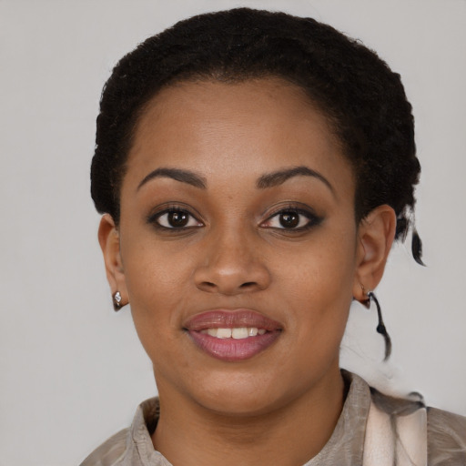 Joyful black young-adult female with short  brown hair and brown eyes
