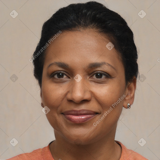 Joyful black adult female with short  brown hair and brown eyes