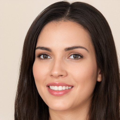 Joyful white young-adult female with long  brown hair and brown eyes