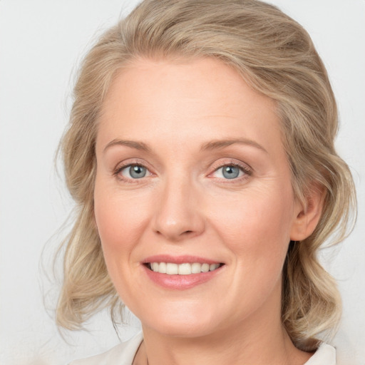 Joyful white young-adult female with medium  brown hair and blue eyes