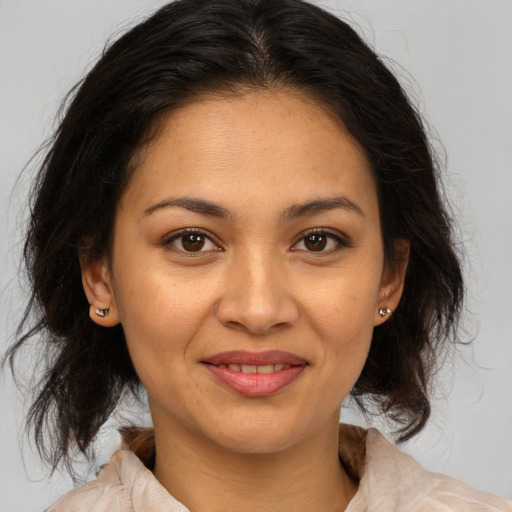 Joyful white adult female with medium  brown hair and brown eyes