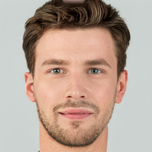 Joyful white young-adult male with short  brown hair and blue eyes