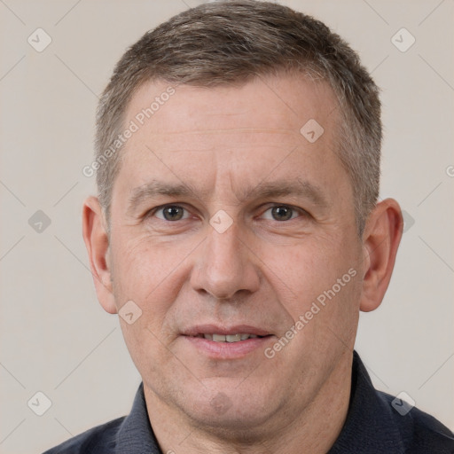 Joyful white adult male with short  brown hair and brown eyes