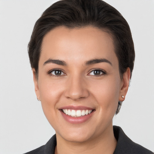 Joyful white young-adult female with short  brown hair and brown eyes