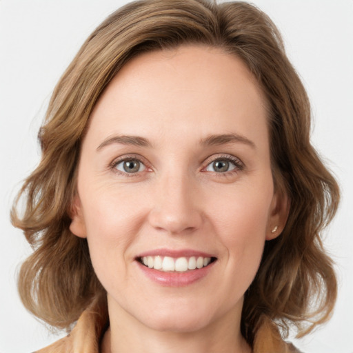 Joyful white young-adult female with medium  brown hair and green eyes