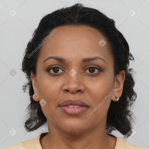 Joyful black adult female with medium  brown hair and brown eyes