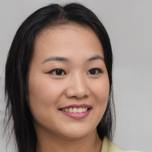 Joyful asian young-adult female with medium  brown hair and brown eyes