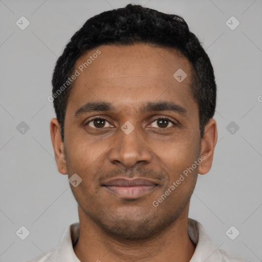 Joyful black young-adult male with short  black hair and brown eyes