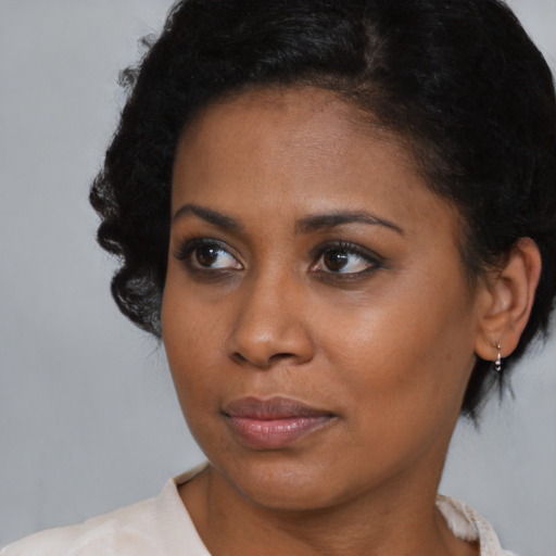 Neutral black young-adult female with short  black hair and brown eyes
