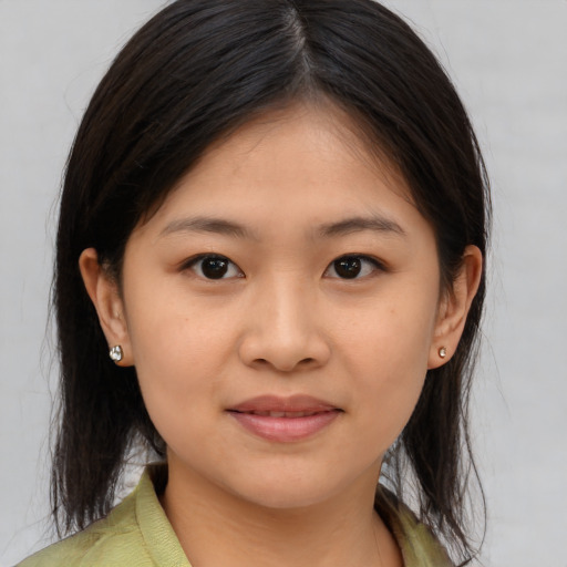 Joyful asian young-adult female with medium  brown hair and brown eyes