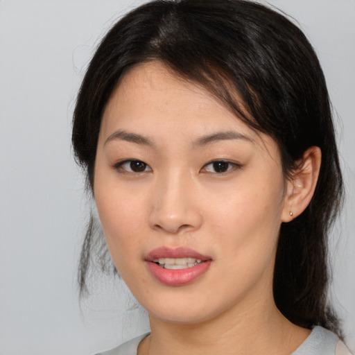 Joyful asian young-adult female with medium  brown hair and brown eyes