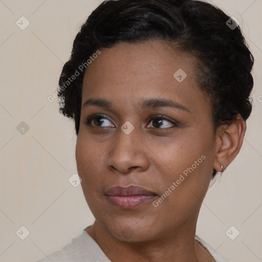 Joyful black young-adult female with short  black hair and brown eyes